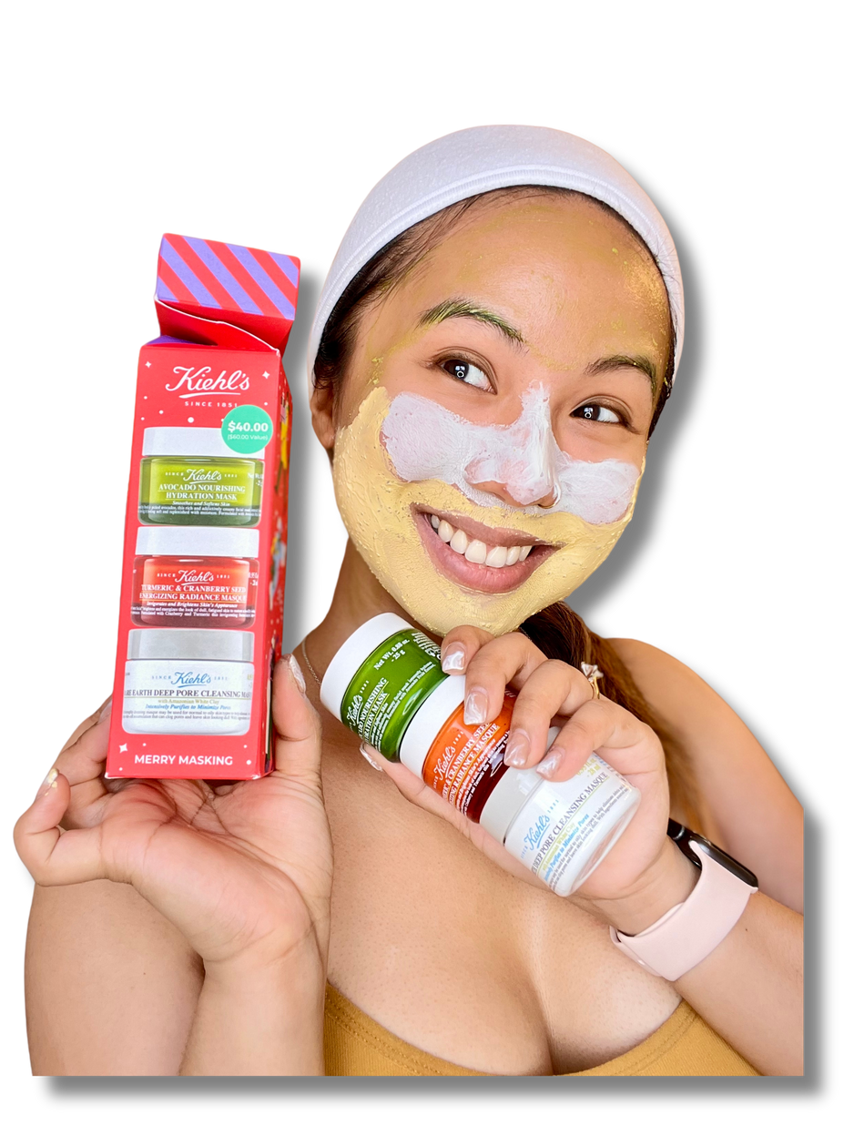 a young woman is smiling while having a face mask on (skincare) and holding up their product by Kiehl's